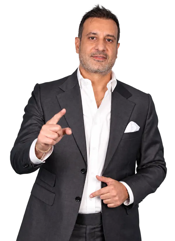 Loai Al Fakir in a charcoal suit, gesturing as he speaks
